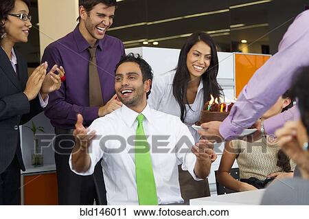 Hispanic co-workers surprising businessman with birthday cake View Large Photo Image Stock Image - Hispanic co-workers surprising businessman with birthday cake. Fotosearch
