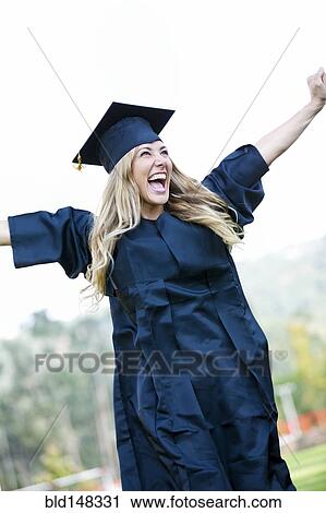 Hispanic college graduate cheering with arms raised View Large Photo Image Stock Image - Hispanic college graduate cheering with arms raised. Fotosearch