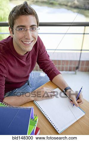Hispanic college student doing homework View Large Photo Image Stock Image - Hispanic college student doing homework. Fotosearch