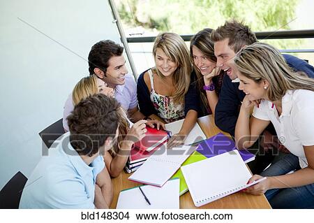 Picture - Hispanic college students doing homework. Fotosearch