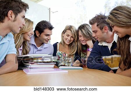 Stock Image - Hispanic college students doing homework. Fotosearch