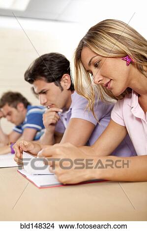 Picture - Hispanic college students studying in classroom. Fotosearch