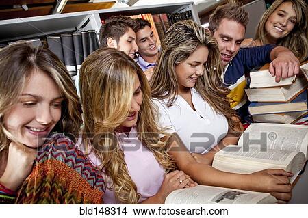 Picture - Hispanic college students studying together in library. Fotosearch