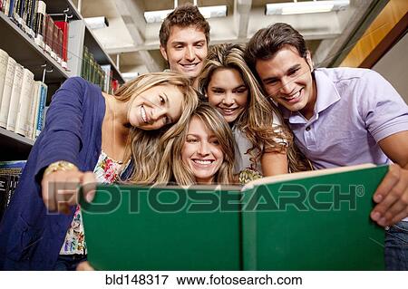 Stock Photo - Hispanic college students studying together in library. Fotosearch