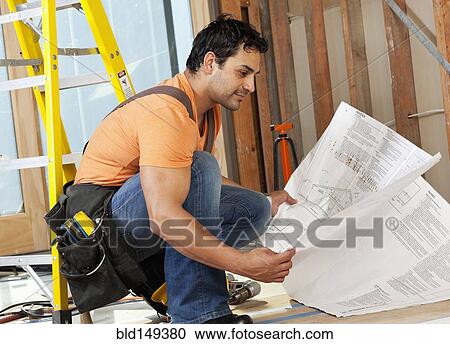 Hispanic construction worker looking at blueprints View Large Photo Image Stock Image - Hispanic construction worker looking at blueprints. Fotosearch
