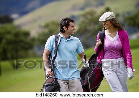 Hispanic couple playing golf together View Large Photo Image Stock Image - Hispanic couple playing golf together. Fotosearch