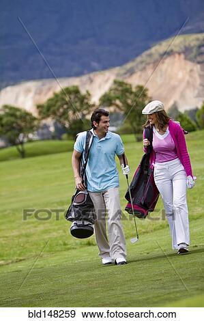 Stock Photo - Hispanic couple playing golf together. Fotosearch