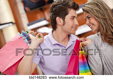 Stock Image - Hispanic couple shopping together. Fotosearch
