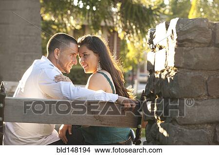 Hispanic couple sitting together on bench View Large Photo Image Picture - Hispanic couple sitting together on bench. Fotosearch