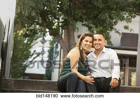 Hispanic couple sitting together on steps View Large Photo Image Stock Image - Hispanic couple sitting together on steps. Fotosearch