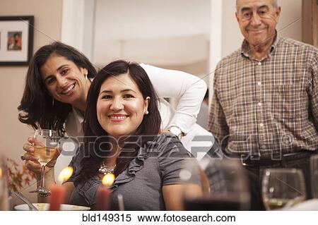 Stock Photography - Hispanic family at Thanksgiving dinner. Fotosearch