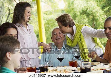 Hispanic family enjoying meal together View Large Photo Image Stock Photo - Hispanic family enjoying meal together. Fotosearch