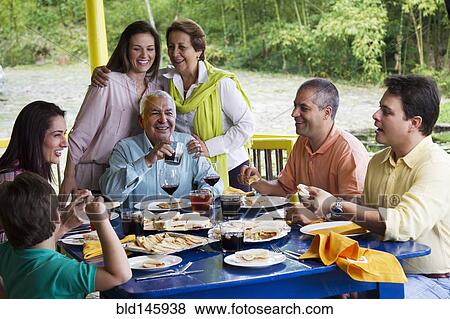 Hispanic family enjoying meal together View Large Photo Image Stock Photo - Hispanic family enjoying meal together. Fotosearch