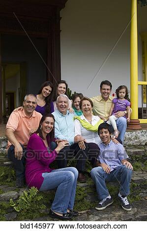 Stock Photo - Hispanic family sitting on steps together. Fotosearch