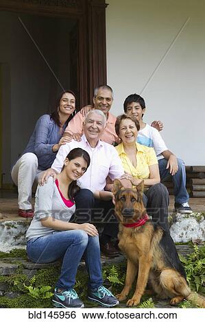 Hispanic family sitting outdoors together View Large Photo Image Stock Photograph - Hispanic family sitting outdoors together. Fotosearch