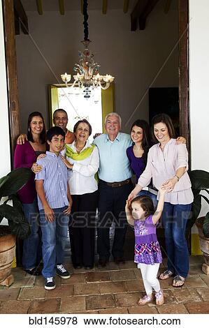 Stock Photo - Hispanic family standing in doorway together. Fotosearch