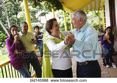 Hispanic family watching senior parents dancing View Large Photo Image Stock Photo - Hispanic family watching senior parents dancing. Fotosearch