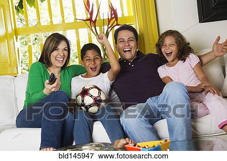 Hispanic family watching soccer on television View Large Photo Image Stock Photo - Hispanic family watching soccer on television. Fotosearch