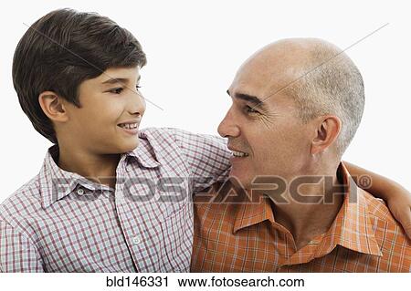 Stock Image - Hispanic father and son hugging. Fotosearch