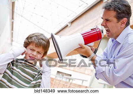 Stock Photo - Hispanic father shouting at son through bullhorn. Fotosearch