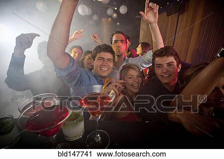 Hispanic friends dancing in nightclub View Large Photo Image Stock Image - Hispanic friends dancing in nightclub. Fotosearch