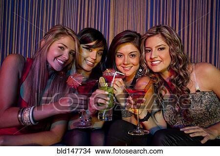 Hispanic friends drinking cocktails in bar View Large Photo Image Picture - Hispanic friends drinking cocktails in bar. Fotosearch