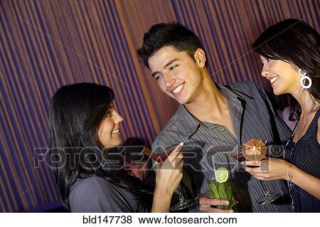 Hispanic friends drinking cocktails in bar View Large Photo Image Stock Photo - Hispanic friends drinking cocktails in bar. Fotosearch