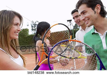 Hispanic friends playing double's tennis View Large Photo Image Stock Photo - Hispanic friends playing double's tennis. Fotosearch