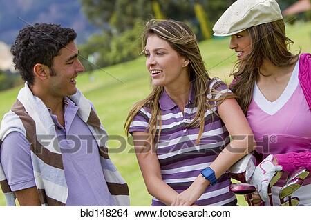 Picture - Hispanic friends playing golf. Fotosearch