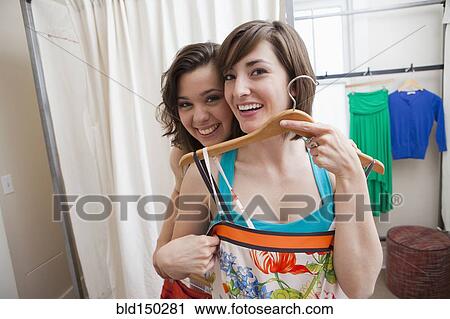 Hispanic friends shopping in clothing store View Large Photo Image Stock Image - Hispanic friends shopping in clothing store. Fotosearch
