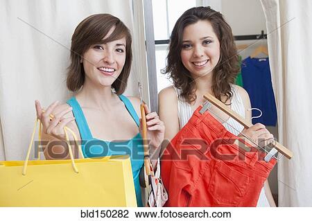Hispanic friends shopping in clothing store View Large Photo Image Stock Image - Hispanic friends shopping in clothing store. Fotosearch