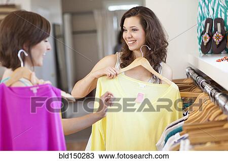 Hispanic friends shopping in clothing store View Large Photo Image Stock Image - Hispanic friends shopping in clothing store. Fotosearch