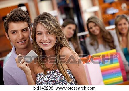Stock Image - Hispanic friends shopping together. Fotosearch