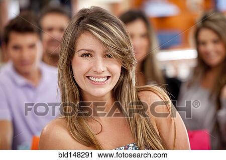 Stock Image - Hispanic friends standing together in store. Fotosearch