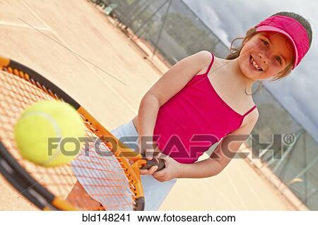 Hispanic girl balancing tennis ball on racquet View Large Photo Image Stock Image - Hispanic girl balancing tennis ball on racquet. Fotosearch