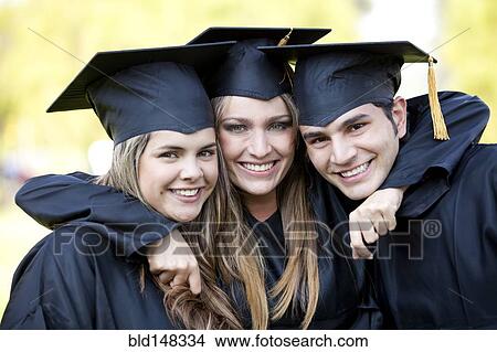 Hispanic graduates in caps and gowns hugging View Large Photo Image Picture - Hispanic graduates in caps and gowns hugging. Fotosearch