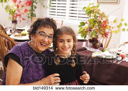 Hispanic grandmother and granddaughter at Thanksgiving dinner View Large Photo Image Picture - Hispanic grandmother and granddaughter at Thanksgiving dinner. Fotosearch