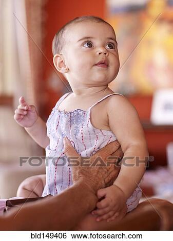Hispanic grandmother holding baby granddaughter View Large Photo Image Stock Photograph - Hispanic grandmother holding baby granddaughter. Fotosearch