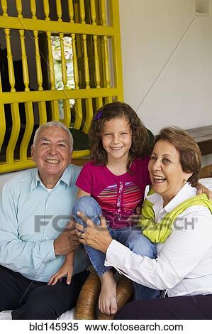 Hispanic grandparents sitting with granddaughter View Large Photo Image Stock Photography - Hispanic grandparents sitting with granddaughter. Fotosearch