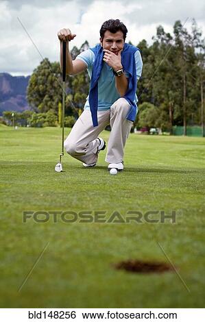 Hispanic man assessing golf course View Large Photo Image Stock Photograph - Hispanic man assessing golf course. Fotosearch
