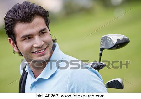 Stock Image - Hispanic man playing golf. Fotosearch
