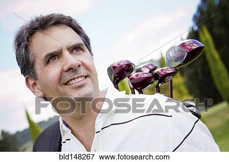 Stock Photo - Hispanic man playing golf. Fotosearch
