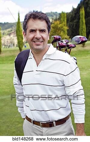 Stock Photo - Hispanic man playing golf. Fotosearch