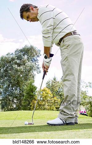 Hispanic man putting golf ball View Large Photo Image Stock Photograph - Hispanic man putting golf ball. Fotosearch