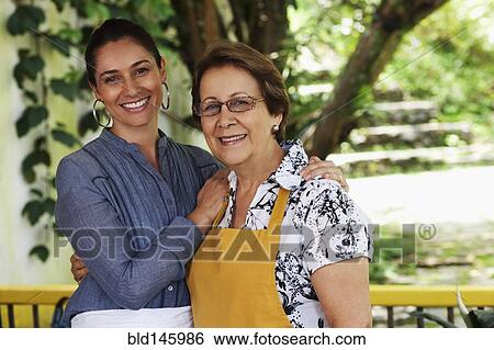 Hispanic mother and daughter hugging View Large Photo Image Stock Photograph - Hispanic mother and daughter hugging. Fotosearch