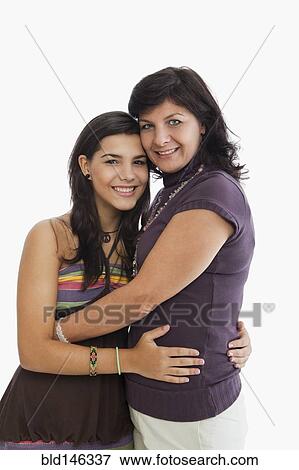 Stock Photo - Hispanic mother hugging daughter. Fotosearch