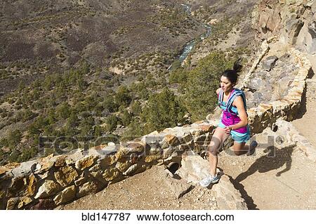 Stock Photo - Hispanic runner training in remote area. Fotosearch