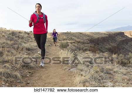 Hispanic runners training in remote area View Large Photo Image Stock Image - Hispanic runners training in remote area. Fotosearch