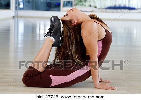 Hispanic woman bending backward on floor View Large Photo Image Stock Photograph - Hispanic woman bending backward on floor. Fotosearch