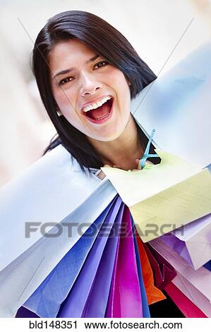 Hispanic woman carrying shopping bags View Large Photo Image Stock Image - Hispanic woman carrying shopping bags. Fotosearch